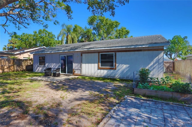 1915 Peppertree Dr, Oldsmar, FL 34677 - back of house with a garden, a fenced backyard, and a patio