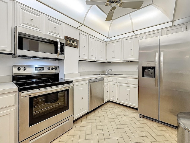 kitchen with light countertops, a sink, a ceiling fan, and stainless steel appliances