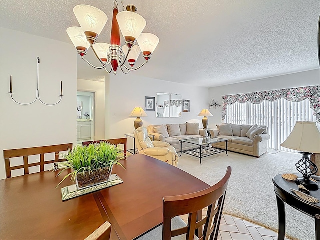 dining area featuring a textured ceiling, an inviting chandelier, and light carpet