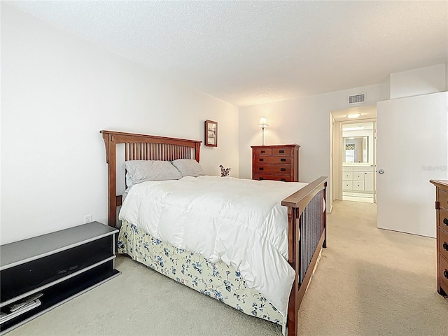 bedroom featuring light colored carpet and visible vents