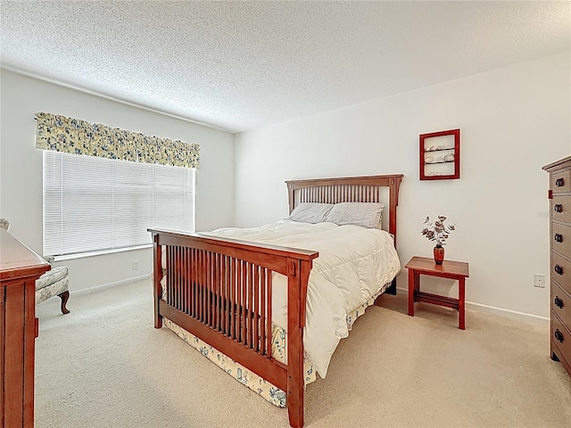 carpeted bedroom featuring baseboards and a textured ceiling