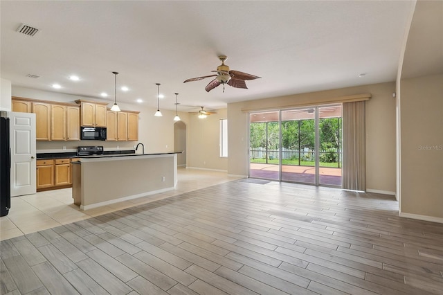 11716 Summer Springs Dr, Riverview, FL 33579 - kitchen featuring open floor plan, a ceiling fan, dark countertops, black appliances, and baseboards