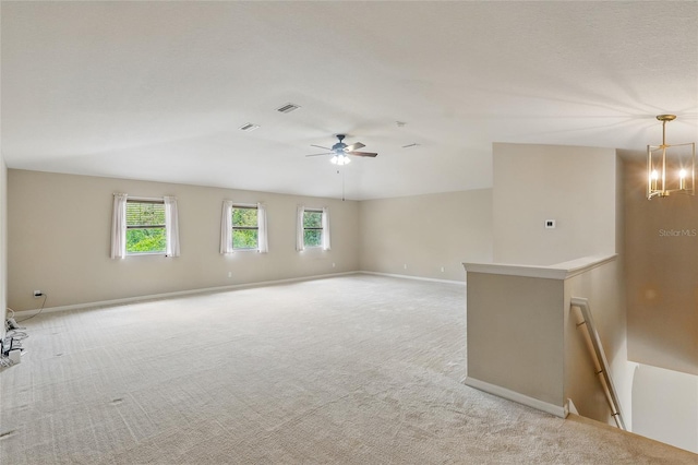 11716 Summer Springs Dr, Riverview, FL 33579 - spare room featuring light colored carpet, healthy amount of natural light, a ceiling fan, and vaulted ceiling