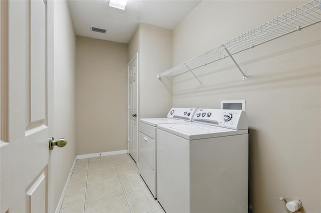 11716 Summer Springs Dr, Riverview, FL 33579 - laundry room with washing machine and dryer, light tile patterned floors, and baseboards