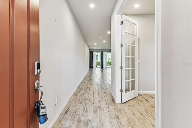entrance foyer with baseboards, recessed lighting, and light wood finished floors