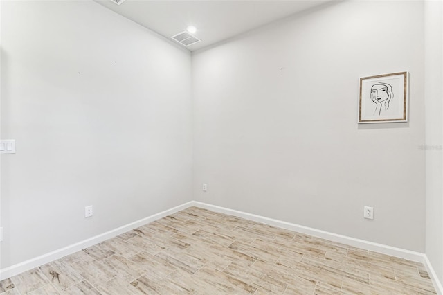 unfurnished room featuring visible vents and baseboards