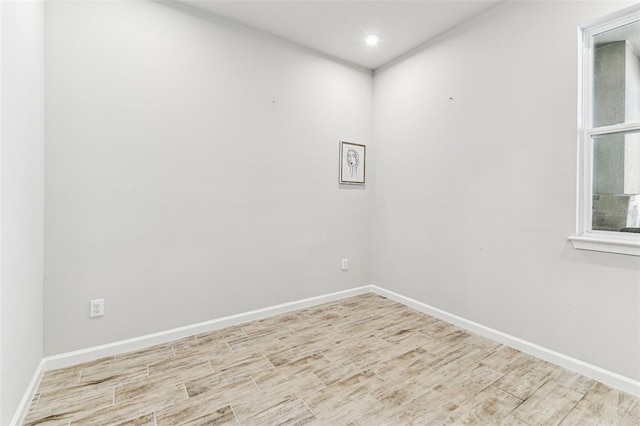 unfurnished room featuring wood finished floors, recessed lighting, and baseboards