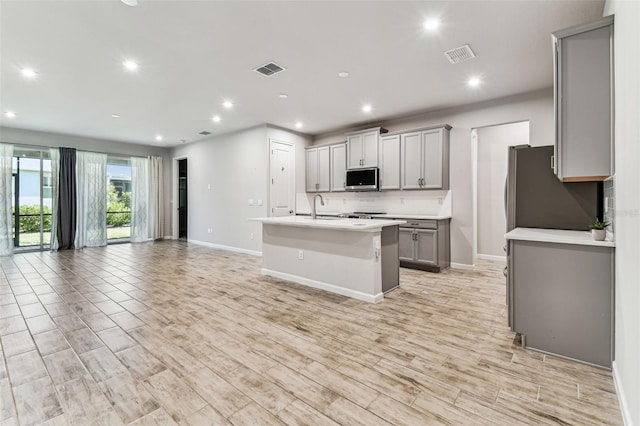 kitchen featuring appliances with stainless steel finishes, visible vents, open floor plan, recessed lighting, and gray cabinets