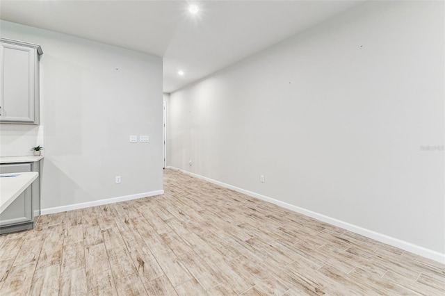 interior space featuring recessed lighting, light wood finished floors, and baseboards