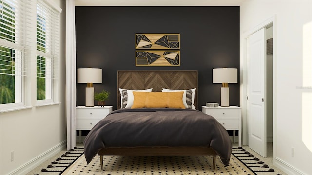 bedroom featuring baseboards and an accent wall