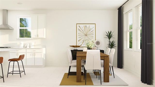 dining space with baseboards and light floors