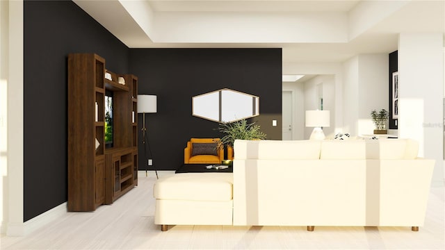 living room featuring baseboards and a raised ceiling