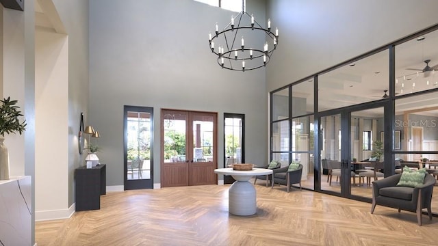 foyer featuring a notable chandelier, a towering ceiling, baseboards, and french doors