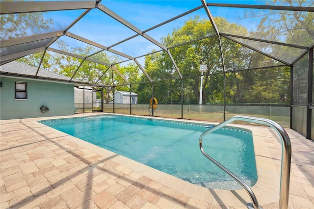 outdoor pool with a shed and a patio