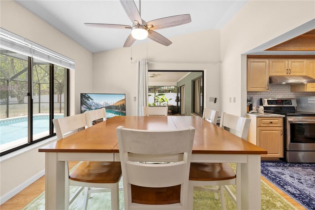 dining area with baseboards and a ceiling fan