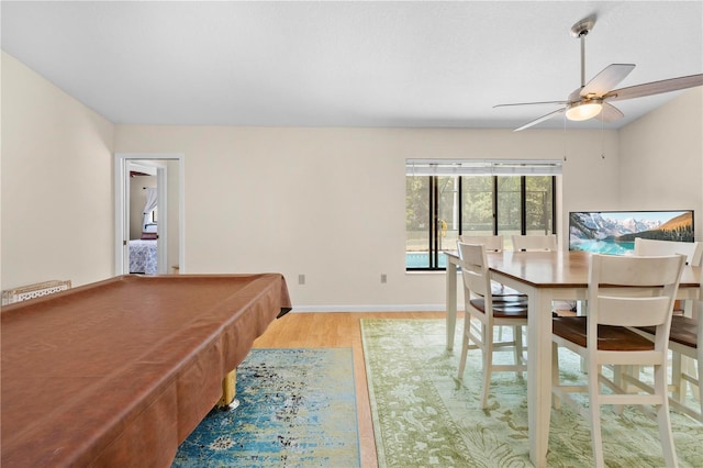 interior space featuring baseboards, wood finished floors, pool table, and ceiling fan