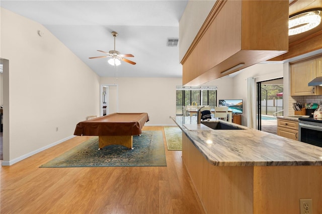game room with lofted ceiling, a ceiling fan, visible vents, and light wood-type flooring