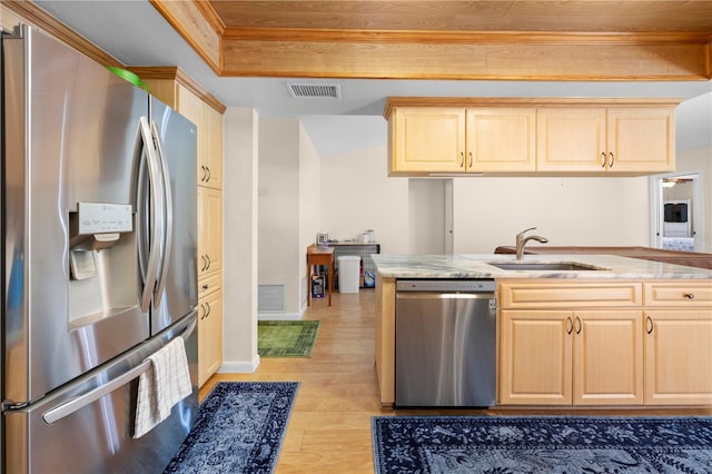 kitchen with light wood-style flooring, light brown cabinetry, a sink, visible vents, and appliances with stainless steel finishes