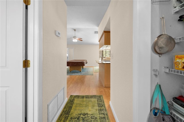 hallway with visible vents and light wood-style flooring