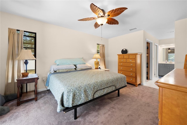 bedroom featuring light carpet, visible vents, a sink, and ceiling fan