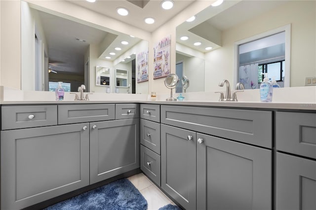 bathroom with recessed lighting, double vanity, and a sink