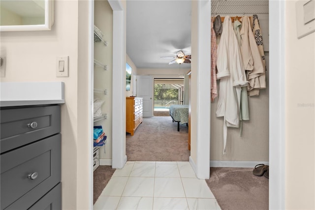 ensuite bathroom featuring baseboards, ensuite bath, vanity, and ceiling fan