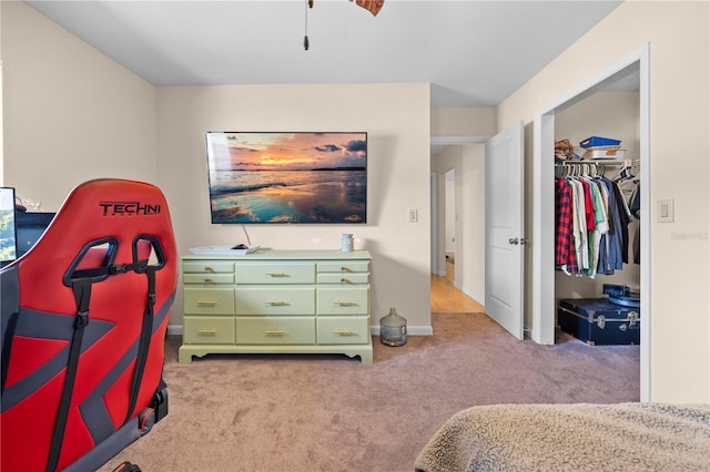 carpeted bedroom with baseboards, a closet, and a walk in closet