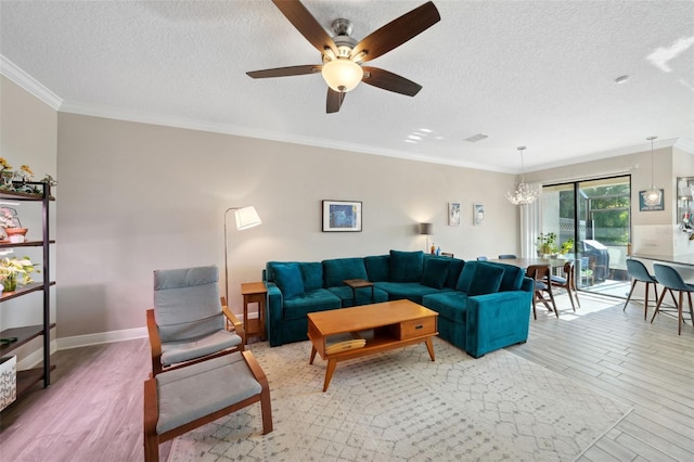 living area featuring light wood-style floors, crown molding, a textured ceiling, and ceiling fan with notable chandelier