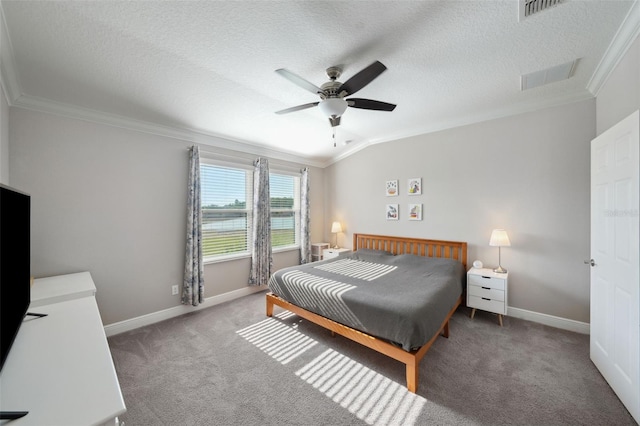 carpeted bedroom with crown molding, a textured ceiling, baseboards, and visible vents