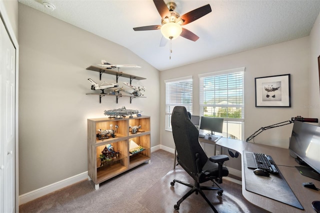 office space with baseboards, carpet, ceiling fan, and vaulted ceiling