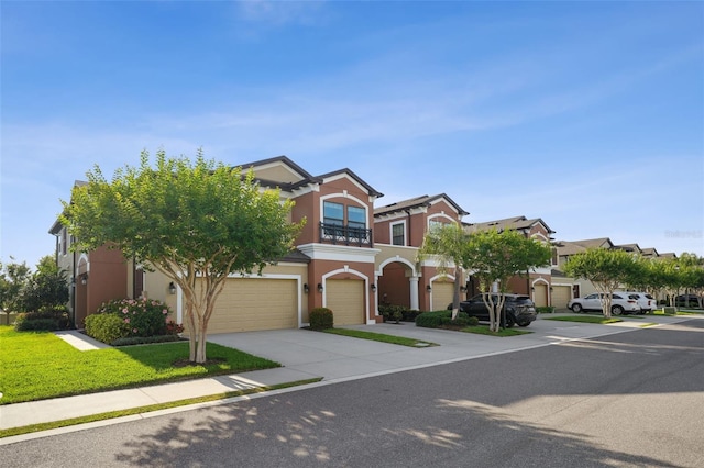 view of front of property featuring an attached garage, stucco siding, and concrete driveway