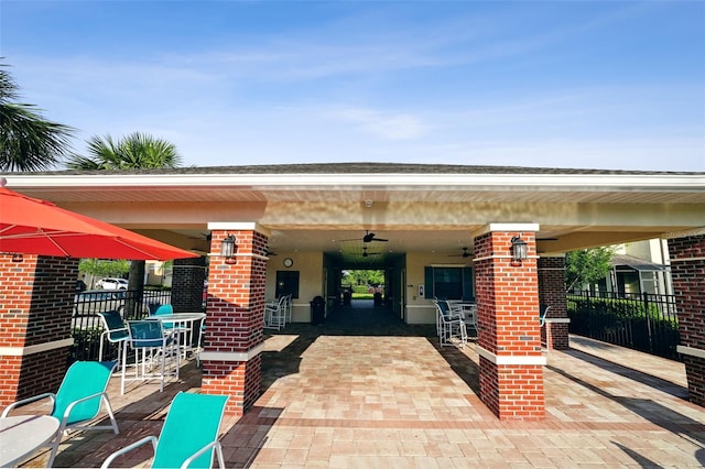 view of patio featuring fence and a ceiling fan