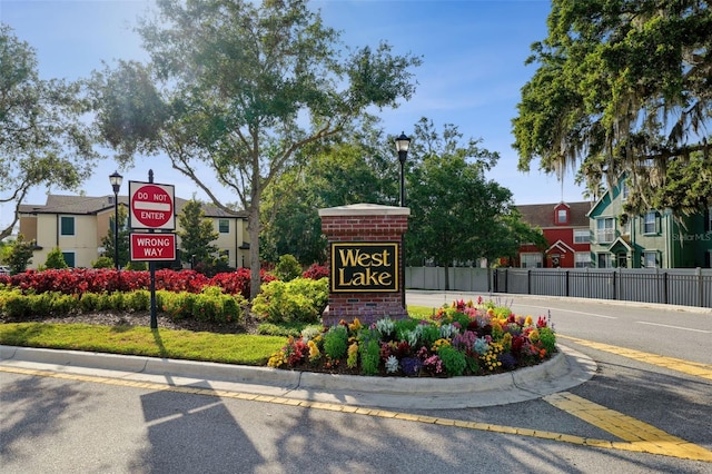 community sign featuring fence