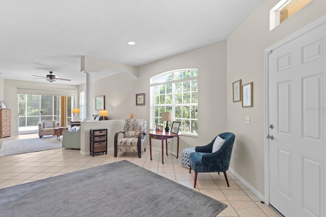 living area featuring recessed lighting, decorative columns, light tile patterned floors, ceiling fan, and baseboards