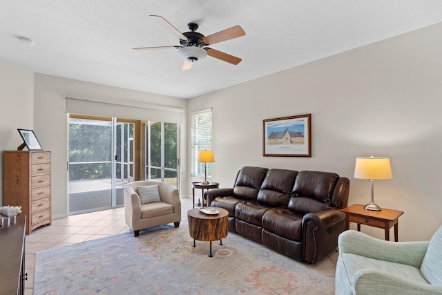 living room featuring light tile patterned floors and a ceiling fan