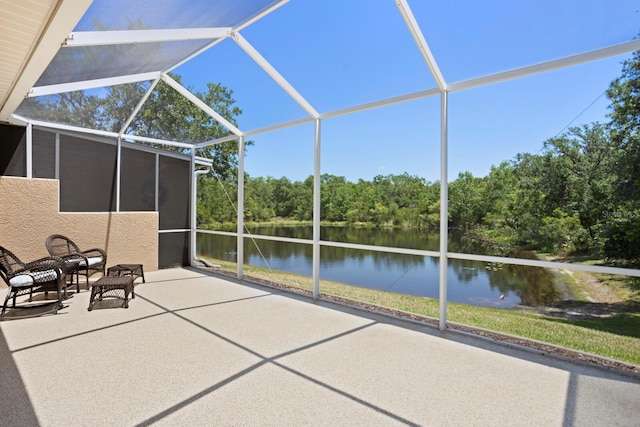 unfurnished sunroom featuring a water view