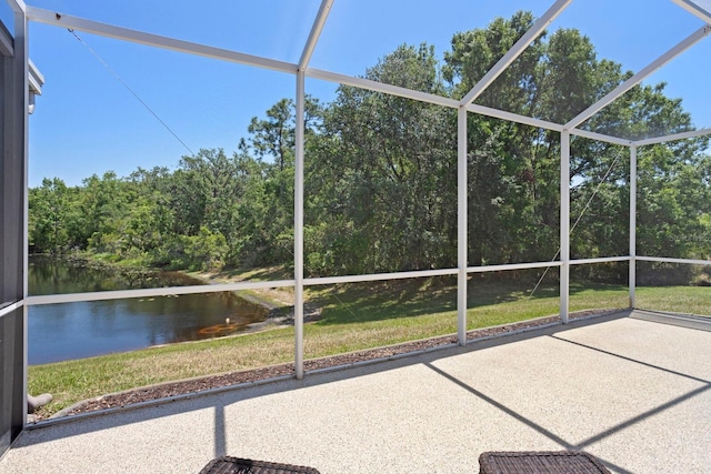 unfurnished sunroom featuring a water view