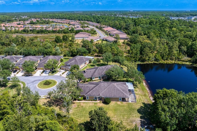 aerial view with a water view, a view of trees, and a residential view