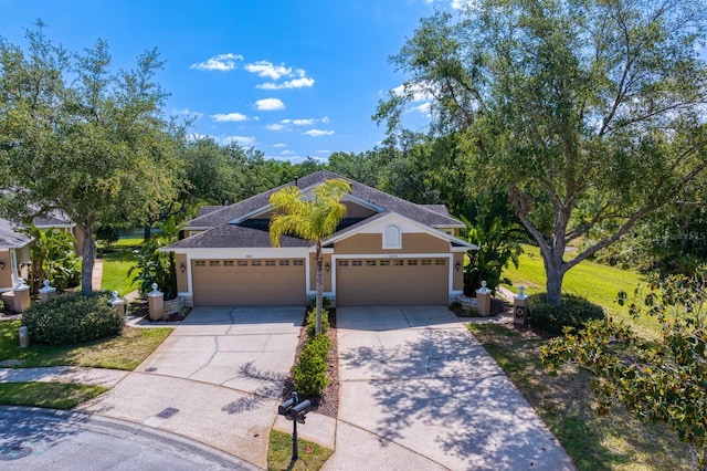 view of front of house with stucco siding, concrete driveway, a shingled roof, and an attached garage