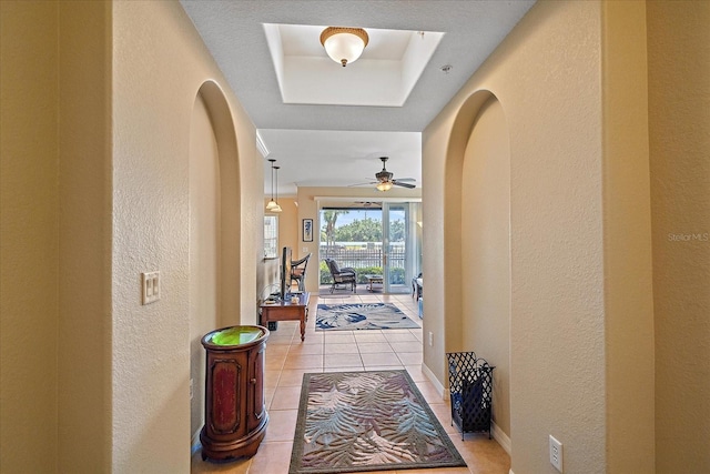 600 Gardens Edge Dr Unit 614, Venice, FL 34285 - entryway with a textured wall, arched walkways, light tile patterned flooring, ceiling fan, and a raised ceiling