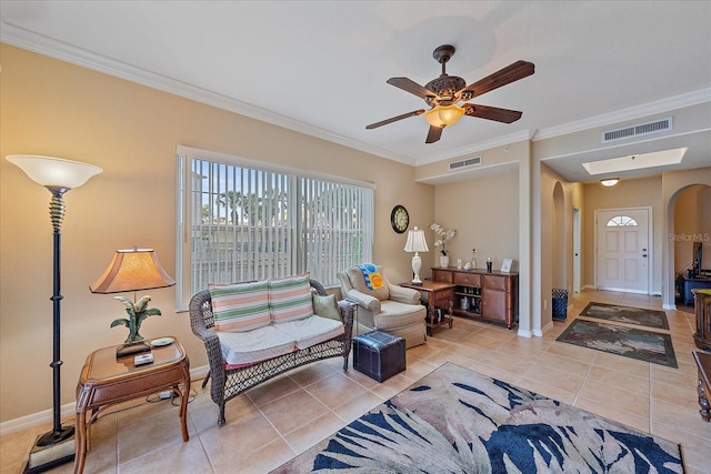 600 Gardens Edge Dr Unit 614, Venice, FL 34285 - living room with arched walkways, light tile patterned floors, crown molding, baseboards, and ceiling fan