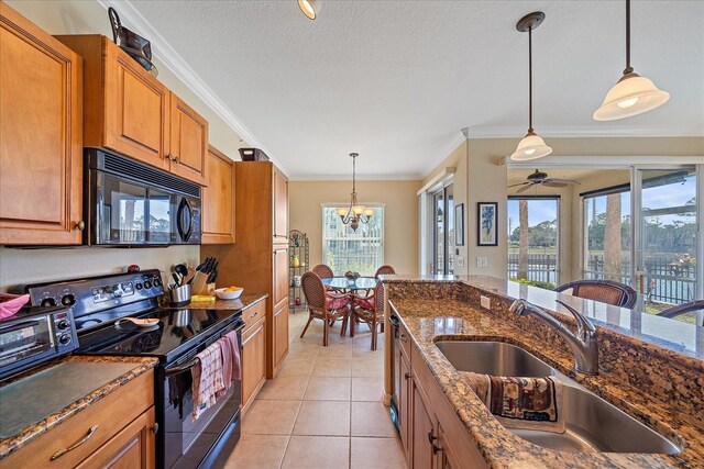 600 Gardens Edge Dr Unit 614, Venice, FL 34285 - kitchen featuring black appliances, brown cabinetry, a sink, crown molding, and a chandelier