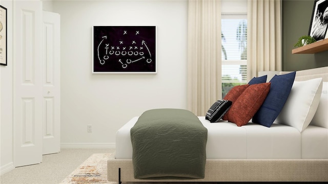 carpeted bedroom featuring baseboards