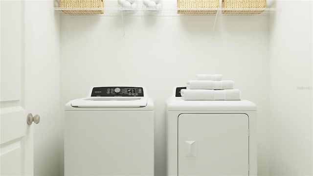 clothes washing area with washing machine and clothes dryer and laundry area