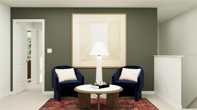 sitting room featuring carpet floors and baseboards