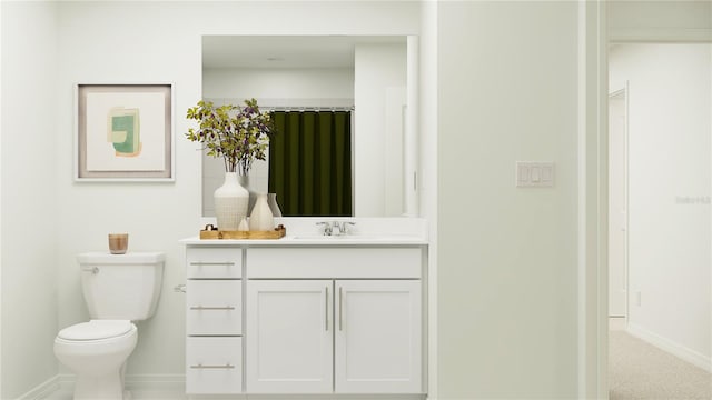 bathroom with baseboards, vanity, and toilet