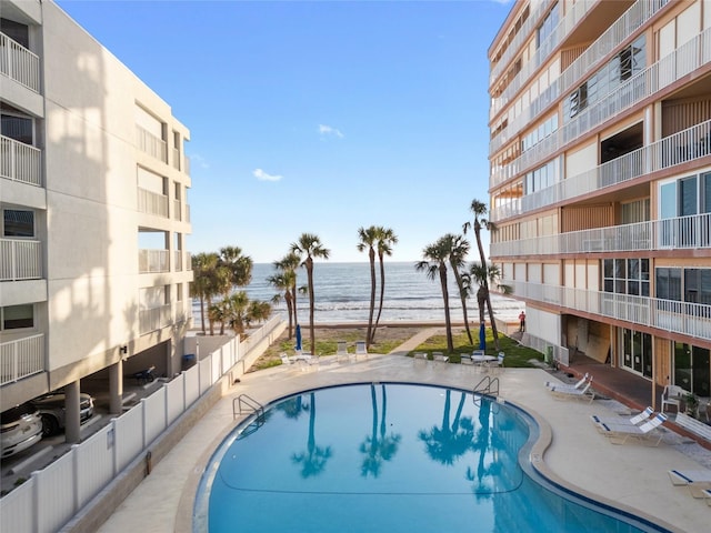 pool with a beach view and a water view