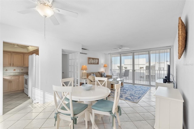 dining room with a ceiling fan and light tile patterned floors