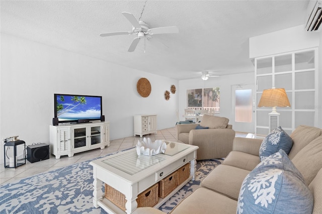 living room with a wall mounted AC, a textured ceiling, tile patterned flooring, and ceiling fan
