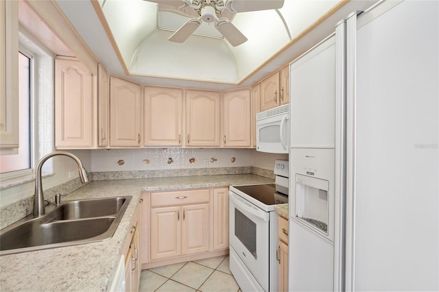 kitchen featuring ceiling fan, light brown cabinets, a sink, and white appliances